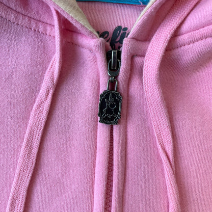 Team Fortress 2 Balloonicorn 2015 WeLoveFine Zip-Up Hoodie is a bright pink unisex colorblock hoodie from Valve’s Team Fortress 2 line, with a detailed 3D plush Balloonicorn hood featuring embroidered eyes, a 3D horn, nose, and ears. It has front pockets, a custom metal Balloonicorn cameo zipper pull, and a light blue printed saddle graphic that wraps from the back to the front. The licensed TF2 neck tag carries 2015 and We Love Fine branding. Super rare.