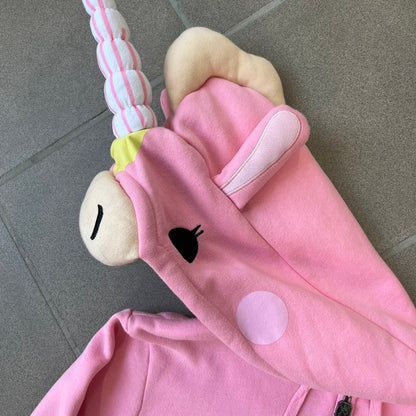 Team Fortress 2 Balloonicorn 2015 WeLoveFine Zip-Up Hoodie is a bright pink unisex colorblock hoodie from Valve’s Team Fortress 2 line, with a detailed 3D plush Balloonicorn hood featuring embroidered eyes, a 3D horn, nose, and ears. It has front pockets, a custom metal Balloonicorn cameo zipper pull, and a light blue printed saddle graphic that wraps from the back to the front. The licensed TF2 neck tag carries 2015 and We Love Fine branding. Super rare.