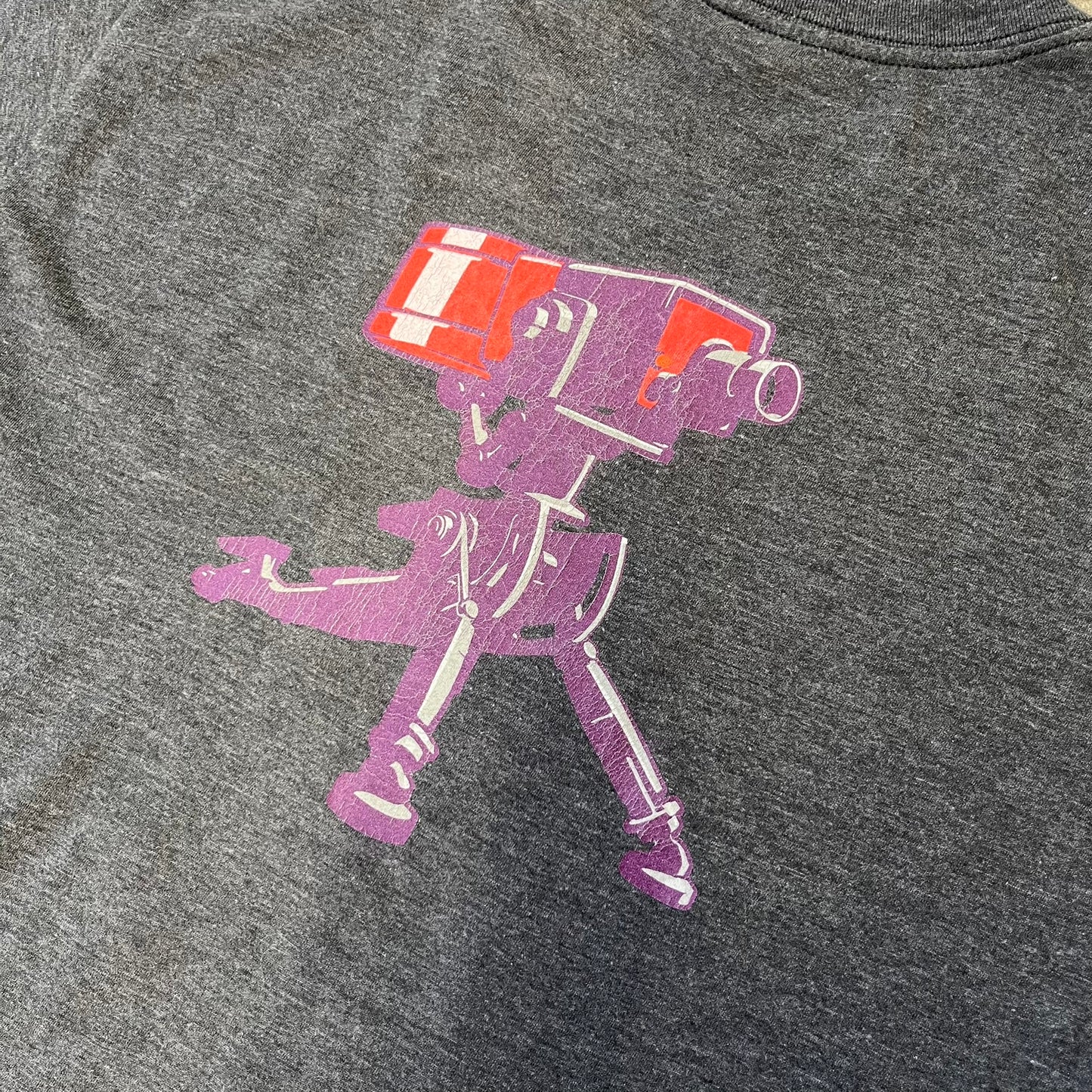 Team Fortress 2 “Balloonicorn & Sentry” 2010s Tee is a dark grey cotton-polyester blend T-shirt with a printed Valve neck tag. The front features a pink Balloonicorn graphic, while the back displays a red Engineer Sentry graphic. This officially licensed Team Fortress 2 T-shirt is a rare release.
