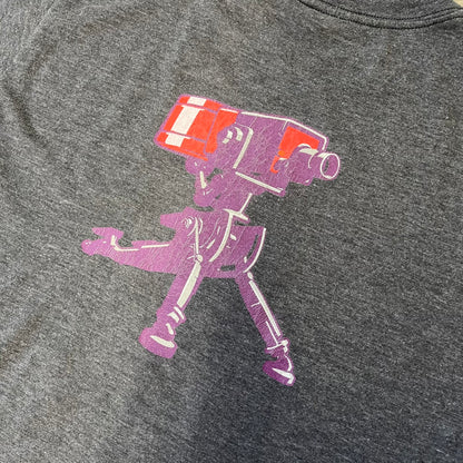Team Fortress 2 “Balloonicorn & Sentry” 2010s Tee is a dark grey cotton-polyester blend T-shirt with a printed Valve neck tag. The front features a pink Balloonicorn graphic, while the back displays a red Engineer Sentry graphic. This officially licensed Team Fortress 2 T-shirt is a rare release.
