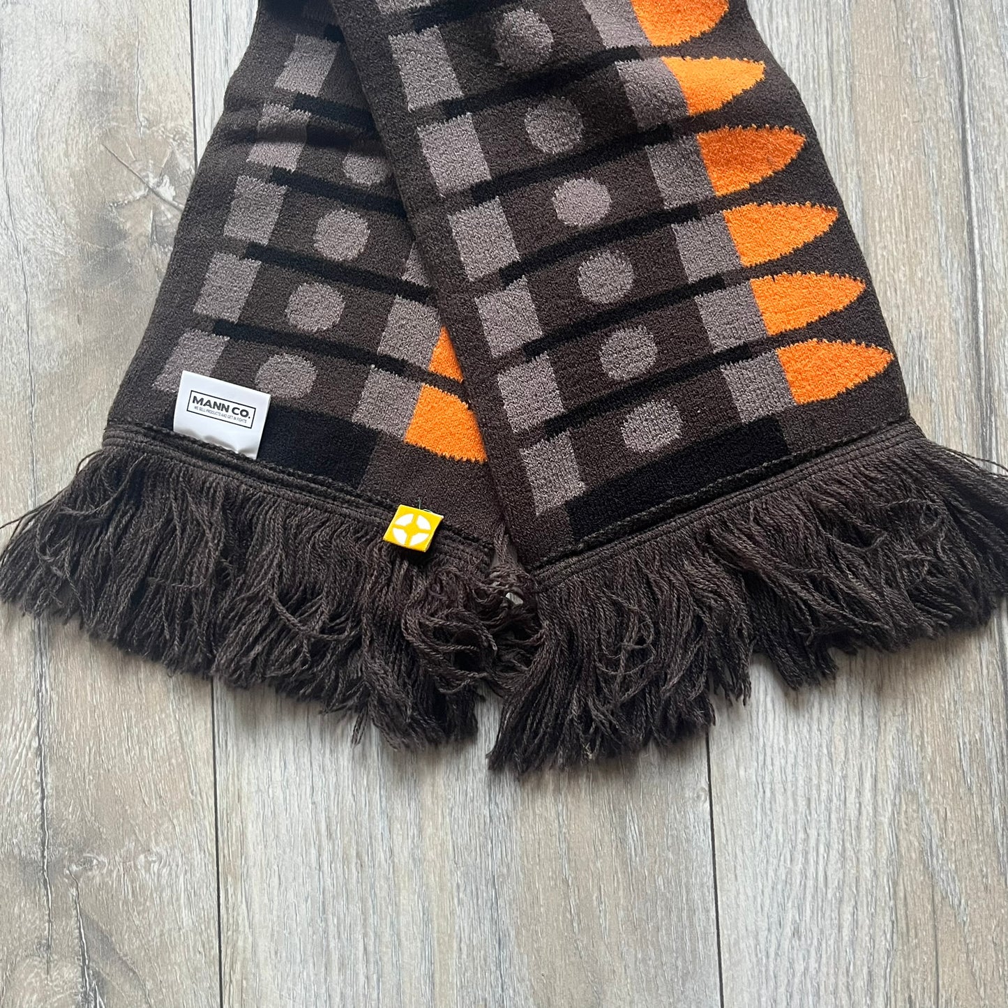 Officially licensed Team Fortress 2 merchandise released in 2014 by The Coop. This scarf is made from soft knit material and features a trompe-l’œil bullet bandolier graphic designed to replicate the ammunition belt worn by the Heavy character. Long and warm in construction, it displays repeated cartridge details along the length of the scarf.