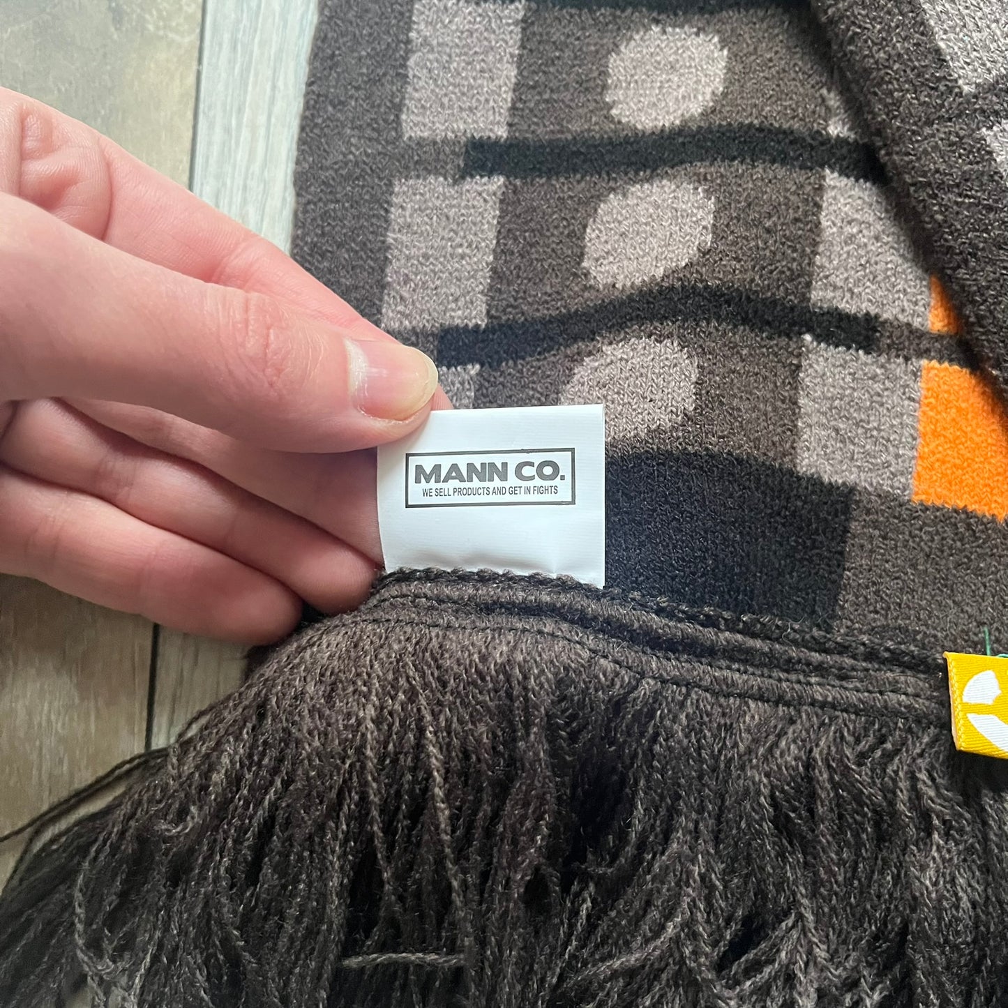 Officially licensed Team Fortress 2 merchandise released in 2014 by The Coop. This scarf is made from soft knit material and features a trompe-l’œil bullet bandolier graphic designed to replicate the ammunition belt worn by the Heavy character. Long and warm in construction, it displays repeated cartridge details along the length of the scarf.