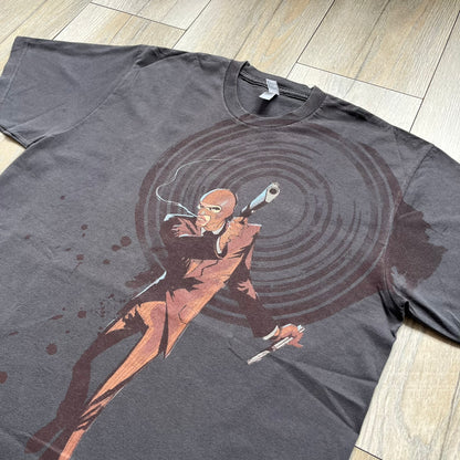 The Team Fortress 2 Red Spy 2010's Gray Tee is an official Valve shirt from the Sniper vs. Spy update, produced during Valve’s Amercian Apparel merch era. This charcoal gray tee features a red Spy character holding a butterfly knife and gun, set against a dark red target graphic with dripping effects. A super rare collectible, it represents one of the original Valve Store releases from over a decade ago.