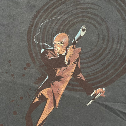 The Team Fortress 2 Red Spy 2010's Gray Tee is an official Valve shirt from the Sniper vs. Spy update, produced during Valve’s Amercian Apparel merch era. This charcoal gray tee features a red Spy character holding a butterfly knife and gun, set against a dark red target graphic with dripping effects. A super rare collectible, it represents one of the original Valve Store releases from over a decade ago.
