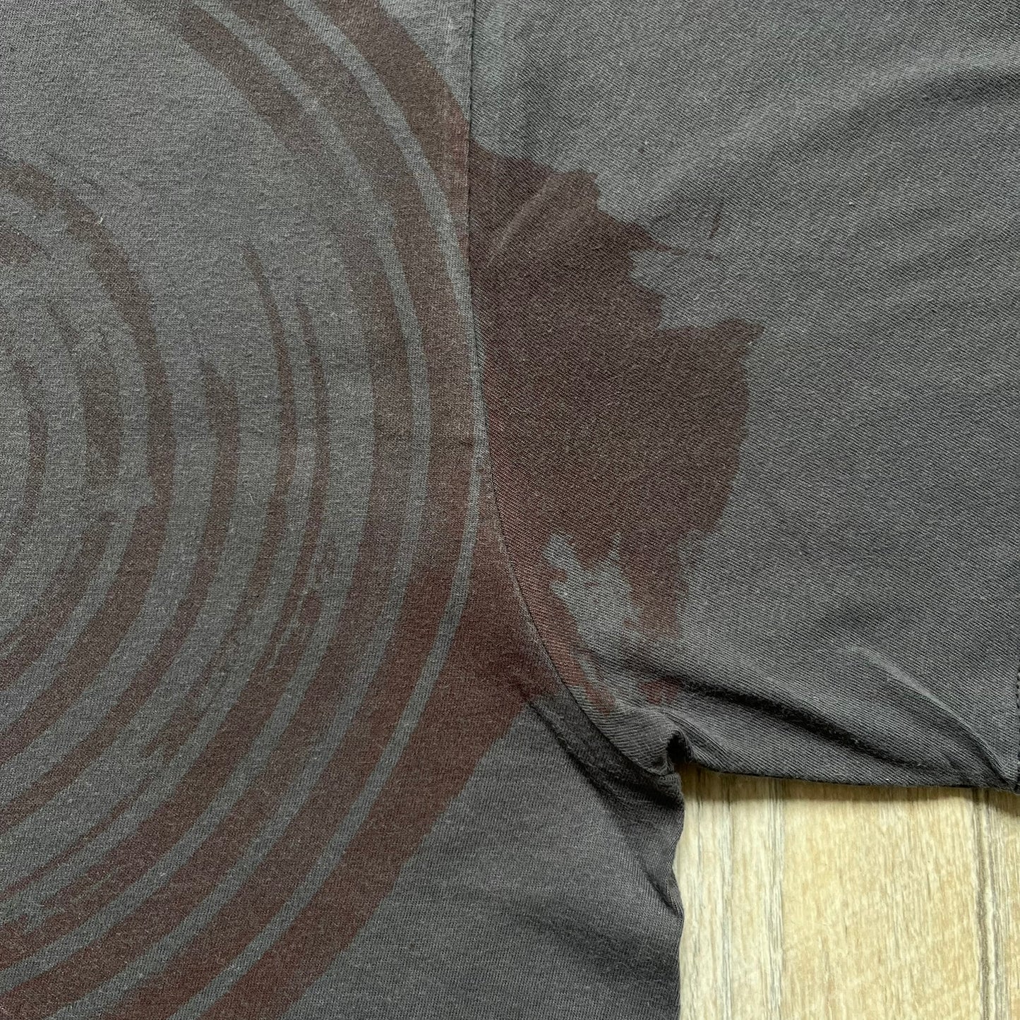 The Team Fortress 2 Red Spy 2010's Gray Tee is an official Valve shirt from the Sniper vs. Spy update, produced during Valve’s Amercian Apparel merch era. This charcoal gray tee features a red Spy character holding a butterfly knife and gun, set against a dark red target graphic with dripping effects. A super rare collectible, it represents one of the original Valve Store releases from over a decade ago.