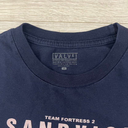The Team Fortress 2 Sandvich 2010 Tee is an official Valve shirt released in December 2010 and produced during Valve’s in-house merch era. This Navy tee features a Sandvich Edible Device (Heavy secondary weapon) on the front, Sandvich blueprint graphic on the back and 'New Meat!' on the sleeve. A super rare collectible, it represents one of the original Valve Store releases from over a decade ago.