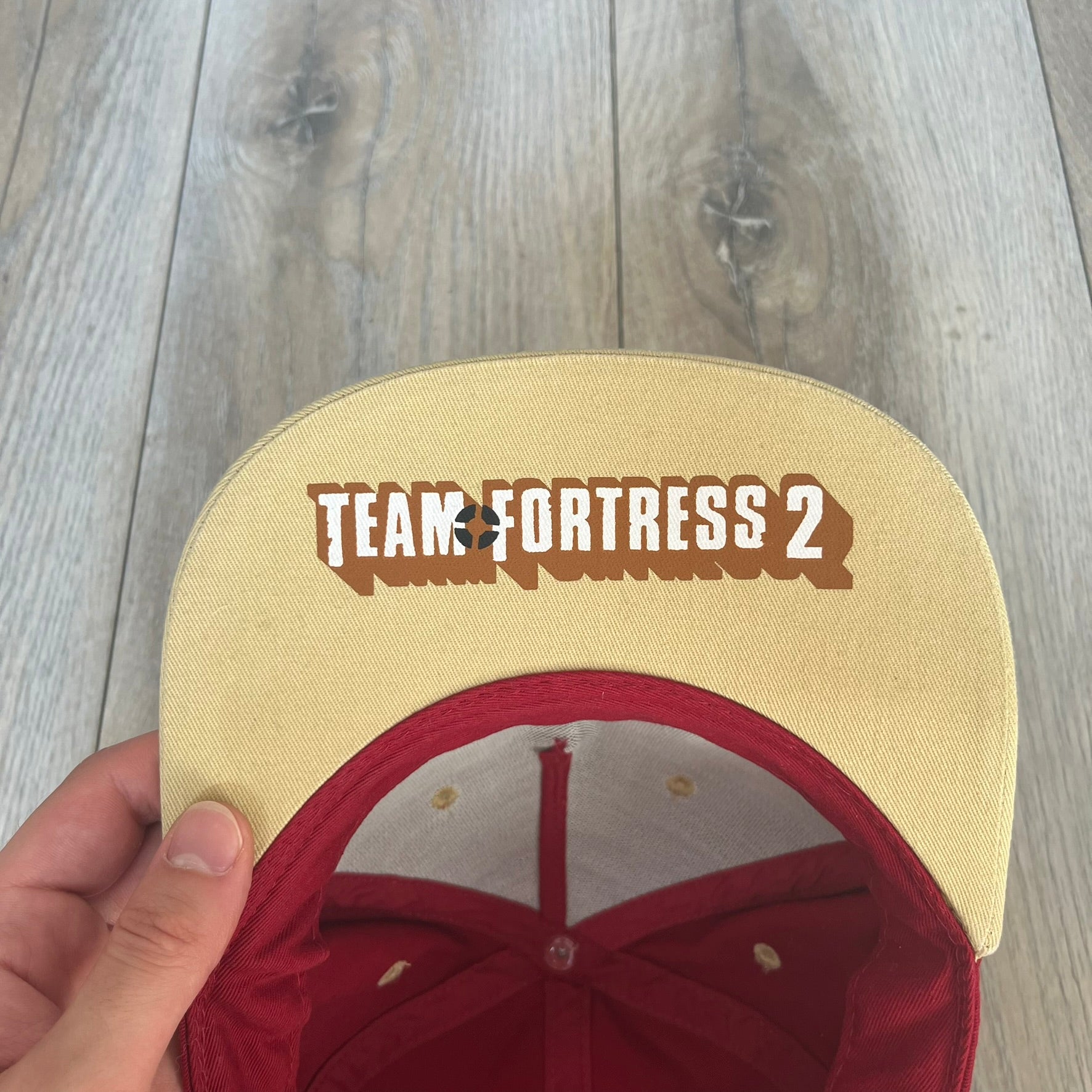 Team Fortress 2 Scout RED LootCrate Hat is a red and yellow cap released with the 2016 LootCrate. The red crown features an embroidered RED Team Scout Hermes Boot logo, while the yellow visor includes a large Team Fortress 2 logo on the underside. The hat combines official game branding with collectible LootCrate exclusivity.&nbsp;