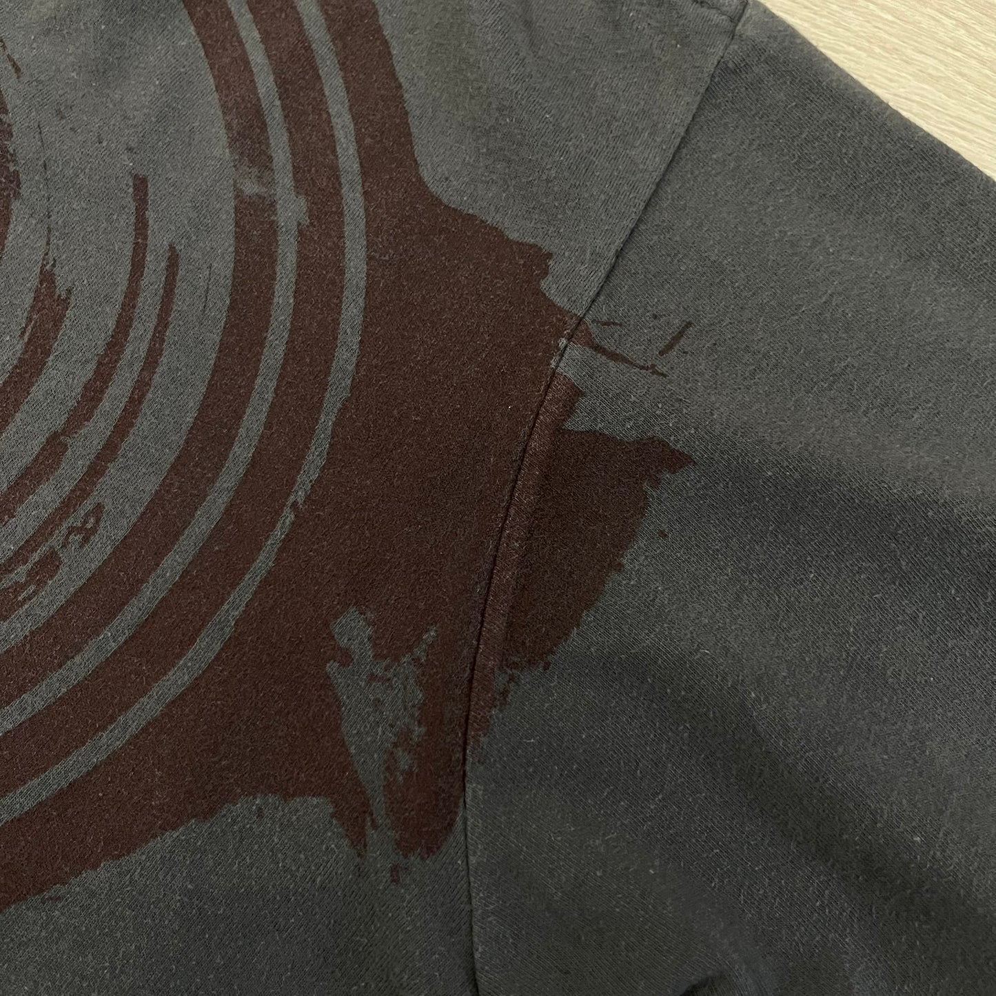 The Team Fortress 2 Spy 2009 Tee is an official Valve shirt from the Sniper vs. Spy update, produced during Valve’s in-house merch era before they switched to a different shirt company. This charcoal tee features a red Spy character holding a butterfly knife and gun, set against a dark red target graphic with dripping effects. A super rare collectible, it represents one of the original Valve Store releases from over a decade ago.