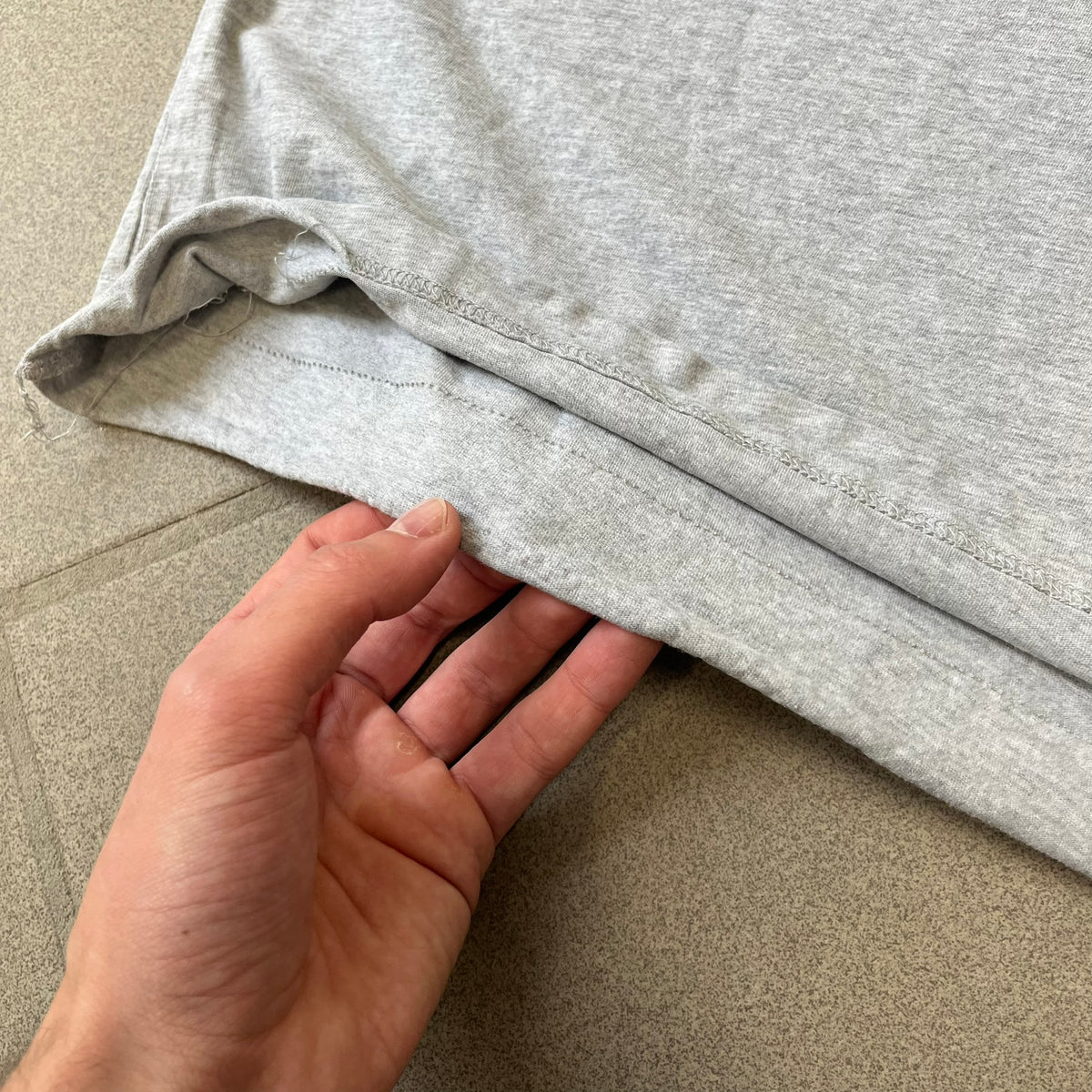 Gray 2014 Marvel tee featuring The Amazing Spider-Man 2 design with a “ripped page” effect showcasing Spider-Man’s face in the center. Text logo sits beneath the graphic for a bold cinematic touch. A collectible piece from the official movie merchandise line.