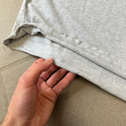 Gray 2014 Marvel tee featuring The Amazing Spider-Man 2 design with a “ripped page” effect showcasing Spider-Man’s face in the center. Text logo sits beneath the graphic for a bold cinematic touch. A collectible piece from the official movie merchandise line.