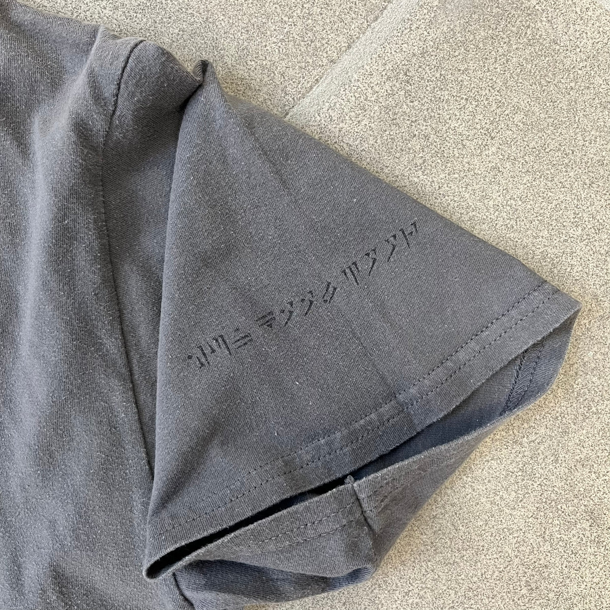 The Elder Scrolls V: Skyrim Premium Edition Tee comes from the 2012 Premium release of the game. Dark gray design with the Skyrim dragon logo printed on the front chest. The upper back has the full “The Elder Scrolls V: Skyrim” text. On the left sleeve there is a text in Dragon language. Made on a Gildan blank.