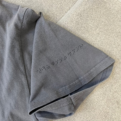 The Elder Scrolls V: Skyrim Premium Edition Tee comes from the 2012 Premium release of the game. Dark gray design with the Skyrim dragon logo printed on the front chest. The upper back has the full “The Elder Scrolls V: Skyrim” text. On the left sleeve there is a text in Dragon language. Made on a Gildan blank.