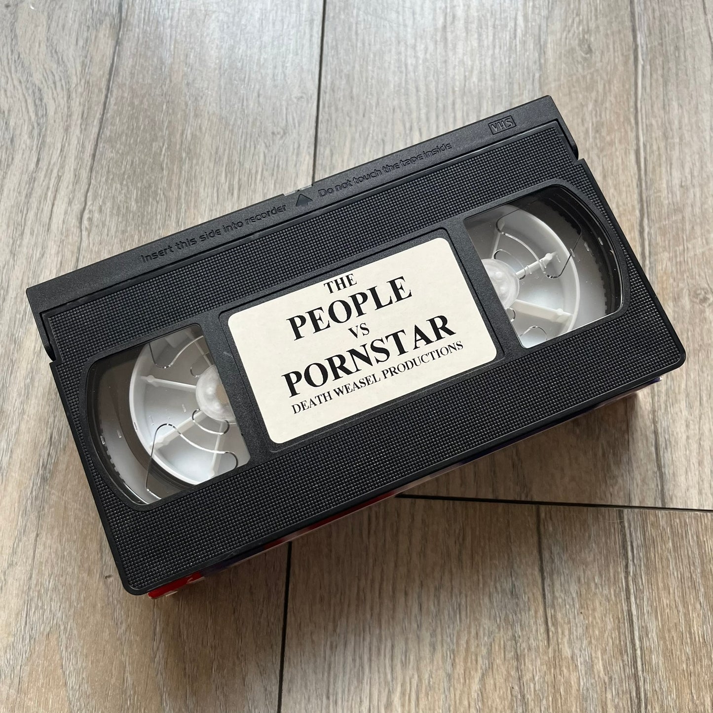 The People Vs. Porn Star is a 22-minute VHS video released in 2000 by Porn Star Skateboards in the United States. The tape features a mix of skate footage, live concert clips with featured artists, staged vignettes, and an on-camera segment with Sean “Vader” Murphy discussing the media attention surrounding the brand at the time. Original cover art includes the subtitle text “Not a Porn flick despite effort made and footage obtained” printed along the bottom.
