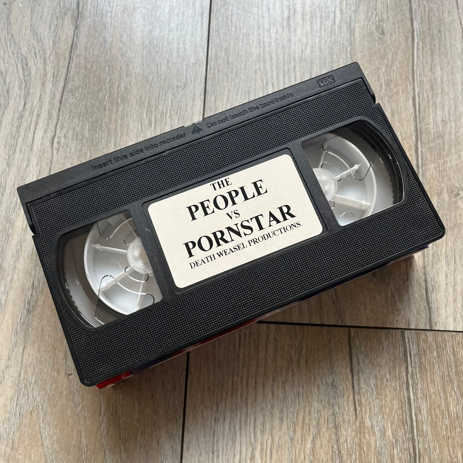 The People Vs. Porn Star is a 22-minute VHS video released in 2000 by Porn Star Skateboards in the United States. The tape features a mix of skate footage, live concert clips with featured artists, staged vignettes, and an on-camera segment with Sean “Vader” Murphy discussing the media attention surrounding the brand at the time. Original cover art includes the subtitle text “Not a Porn flick despite effort made and footage obtained” printed along the bottom.