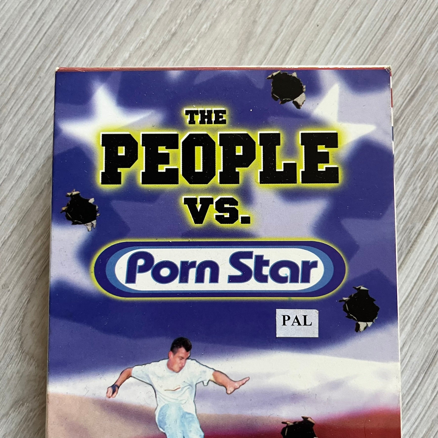 The People Vs. Porn Star is a 22-minute VHS video released in 2000 by Porn Star Skateboards in the United States. The tape features a mix of skate footage, live concert clips with featured artists, staged vignettes, and an on-camera segment with Sean “Vader” Murphy discussing the media attention surrounding the brand at the time. Original cover art includes the subtitle text “Not a Porn flick despite effort made and footage obtained” printed along the bottom.