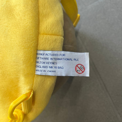 The Simpsons 1990s Homer Simpson Head Backpack is a novelty backpack shaped like a 3D Homer Simpson head. The design is fully yellow with soft sculpted facial features including eyes and nose, a molded mouth, and protruding ears. The hair detail wraps around the back, with the top strands functioning as a hanger. It includes yellow shoulder straps and a single main compartment.