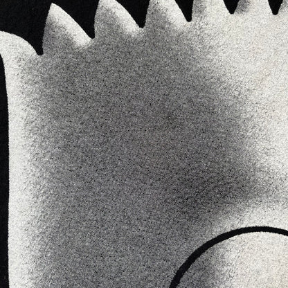 The Simpsons 1999 Bart Face Black Tee features a black T-shirt with a large front graphic of Bart Simpson’s face in black, grey, and white, showing a gritted-teeth expression. Small Matt Groening 1999 licensing text is printed below the graphic.
