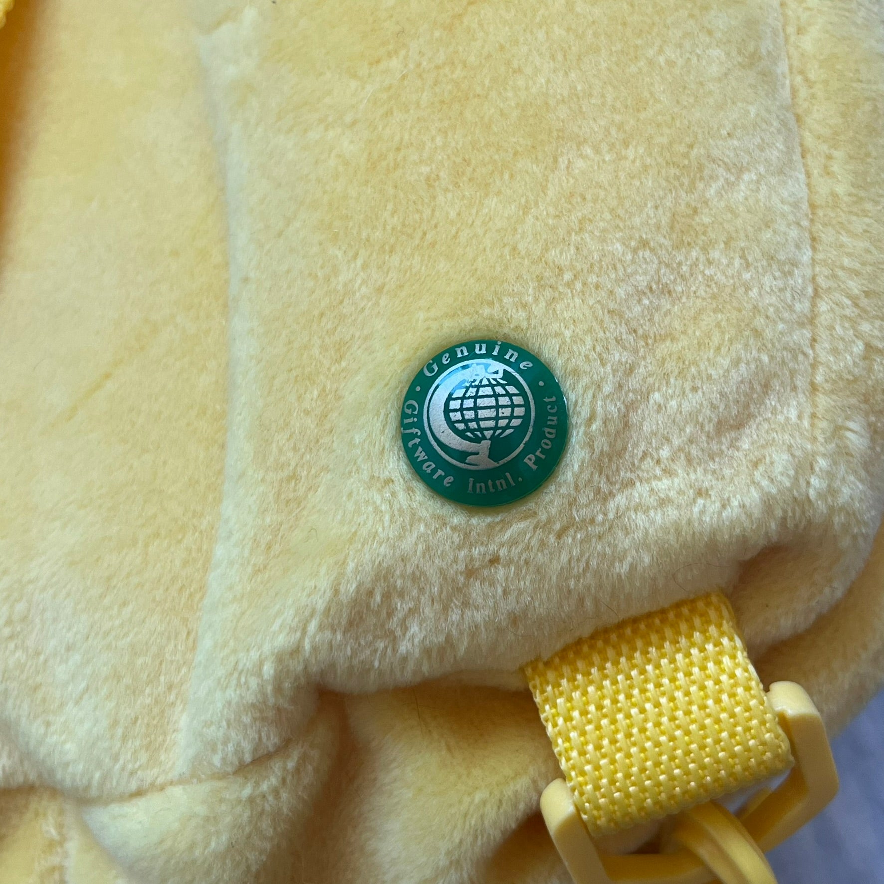 The Simpsons 1990's Bart Simpson Head Backpack is a novelty backpack shaped like a 3D Bart Simpson head. The design is fully yellow with soft sculpted facial features including eyes and nose, a molded mouth, and protruding hair. It includes yellow shoulder straps and a single main compartment.