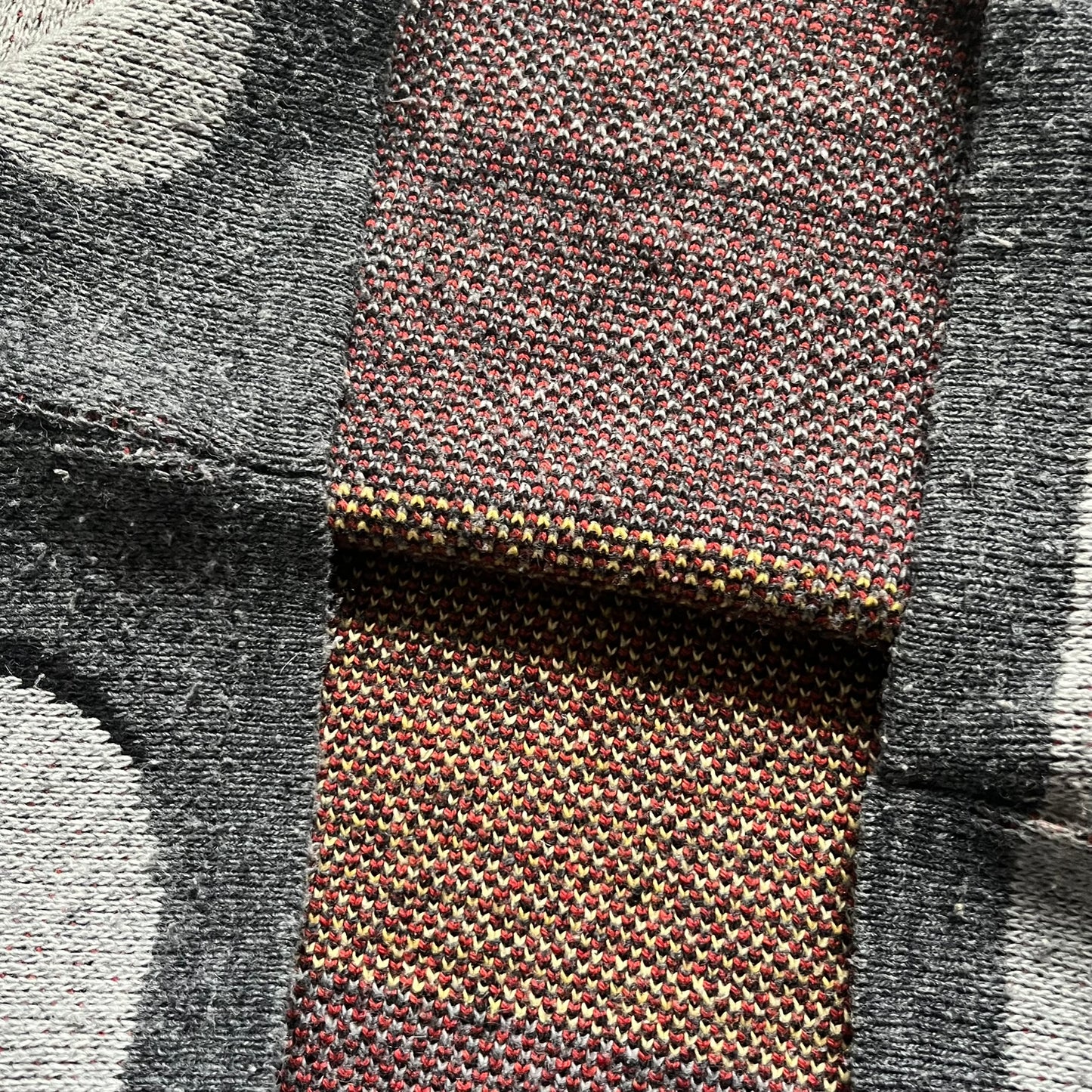 The Simpsons “Bart Freestyle” 2003 Knit Sweater is a gray knit featuring a large woven graphic of Bart snowboarding on the front, with “Bart” text placed below the character. On the back, in the same position as the front graphic, there is “Freestyle” text.&nbsp;It includes a Matt Groening The Simpsons 2003 FOX neck tag.