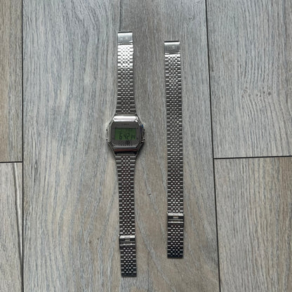 Timex x Maison Margiela MM6 Gift Set TWG065600 is a collaborative reinterpretation of the classic Timex T80, released on October 24, 2024. Crafted from polished and brushed stainless steel, it features a 36mm digital case with Timex branding and a distinctive 0–23 numeral layout, including a subtle circled “6” nod to MM6 design language. The watch offers 100 ft water resistance, mineral glass, backlight, alarm, timer, and date functions, and is presented as a 2-in-1 gift set with an additional standalone st