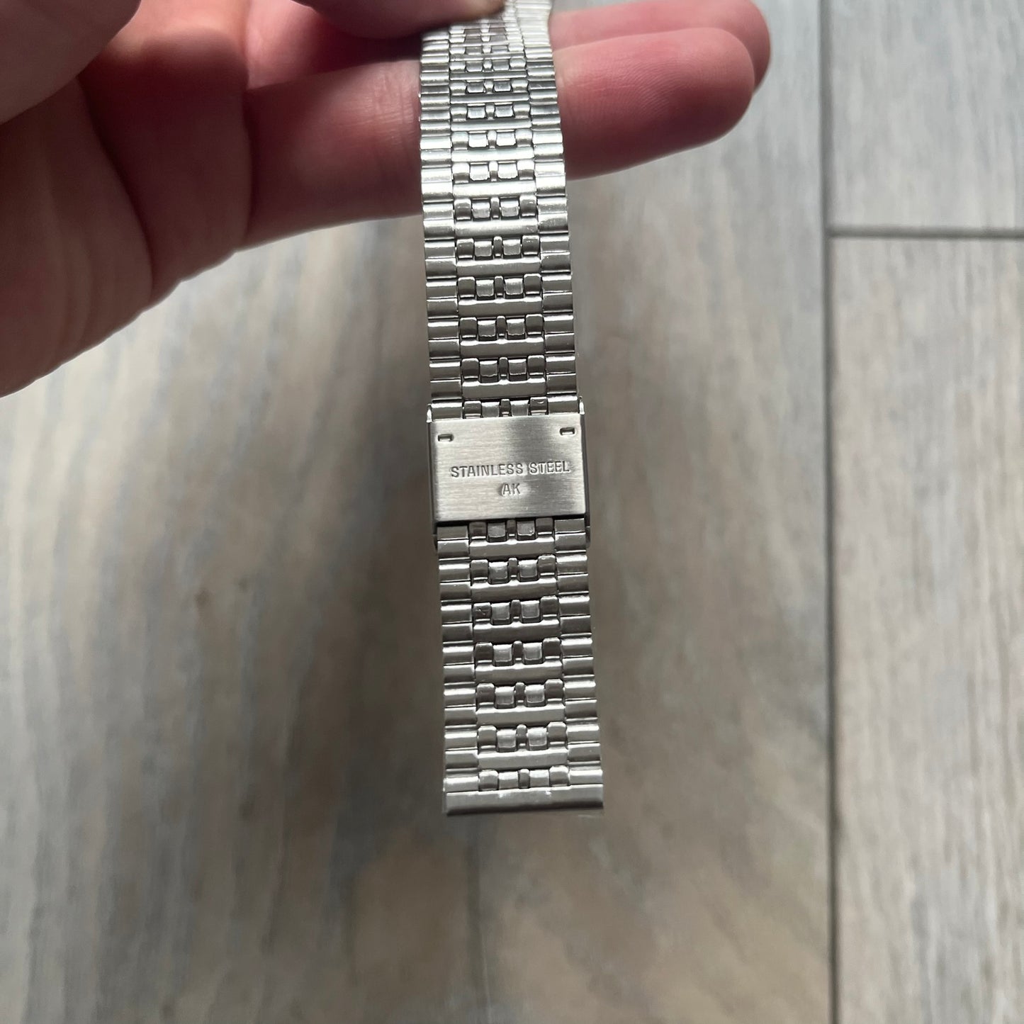 Timex x Maison Margiela MM6 Gift Set TWG065600 is a collaborative reinterpretation of the classic Timex T80, released on October 24, 2024. Crafted from polished and brushed stainless steel, it features a 36mm digital case with Timex branding and a distinctive 0–23 numeral layout, including a subtle circled “6” nod to MM6 design language. The watch offers 100 ft water resistance, mineral glass, backlight, alarm, timer, and date functions, and is presented as a 2-in-1 gift set with an additional standalone st