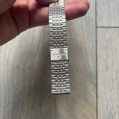 Timex x Maison Margiela MM6 Gift Set TWG065600 is a collaborative reinterpretation of the classic Timex T80, released on October 24, 2024. Crafted from polished and brushed stainless steel, it features a 36mm digital case with Timex branding and a distinctive 0–23 numeral layout, including a subtle circled “6” nod to MM6 design language. The watch offers 100 ft water resistance, mineral glass, backlight, alarm, timer, and date functions, and is presented as a 2-in-1 gift set with an additional standalone st