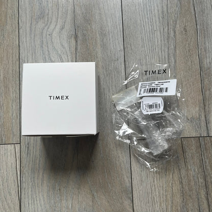 Timex x Maison Margiela MM6 Gift Set TWG065600 is a collaborative reinterpretation of the classic Timex T80, released on October 24, 2024. Crafted from polished and brushed stainless steel, it features a 36mm digital case with Timex branding and a distinctive 0–23 numeral layout, including a subtle circled “6” nod to MM6 design language. The watch offers 100 ft water resistance, mineral glass, backlight, alarm, timer, and date functions, and is presented as a 2-in-1 gift set with an additional standalone st
