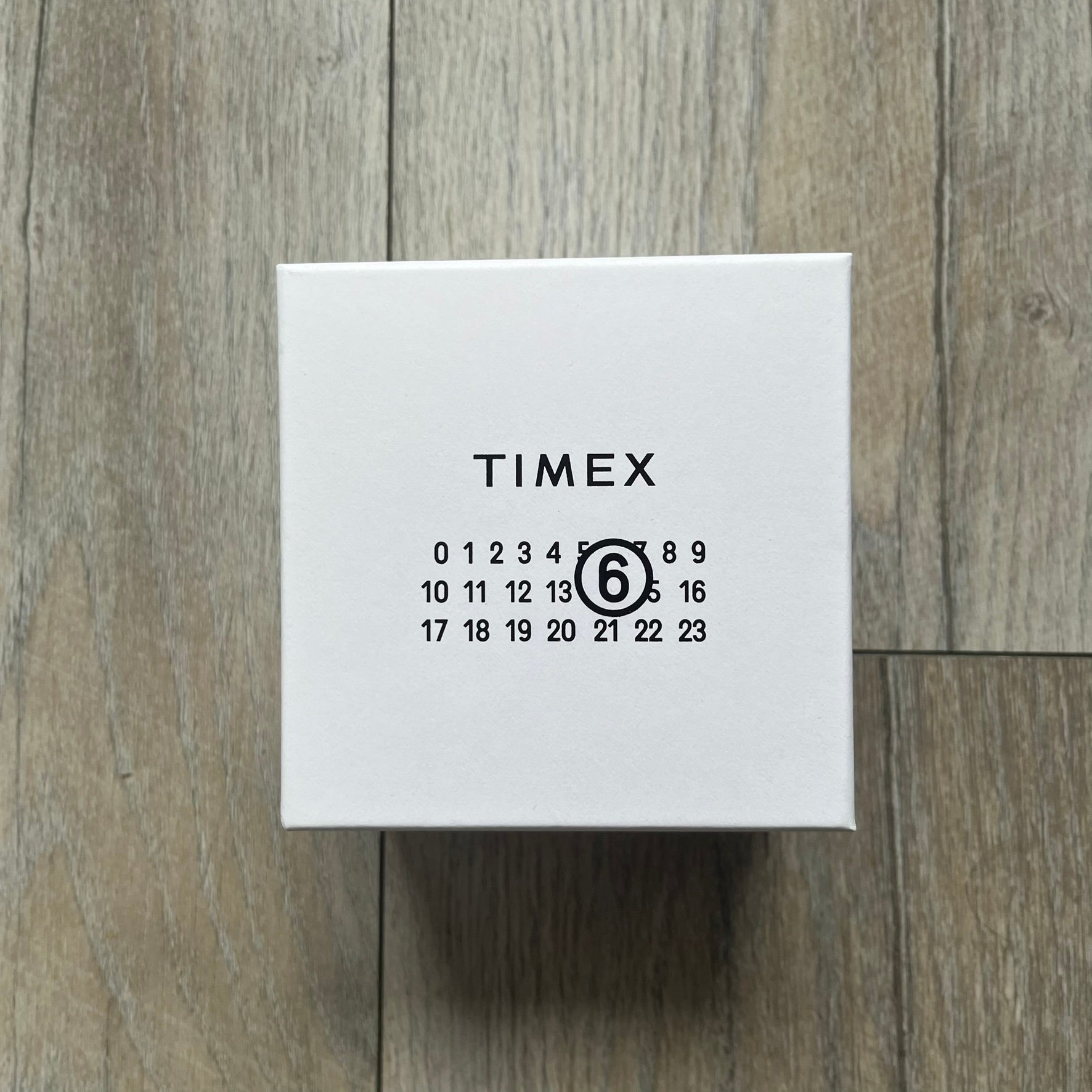 Timex x Maison Margiela MM6 Gift Set TWG065600 is a collaborative reinterpretation of the classic Timex T80, released on October 24, 2024. Crafted from polished and brushed stainless steel, it features a 36mm digital case with Timex branding and a distinctive 0–23 numeral layout, including a subtle circled “6” nod to MM6 design language. The watch offers 100 ft water resistance, mineral glass, backlight, alarm, timer, and date functions, and is presented as a 2-in-1 gift set with an additional standalone st