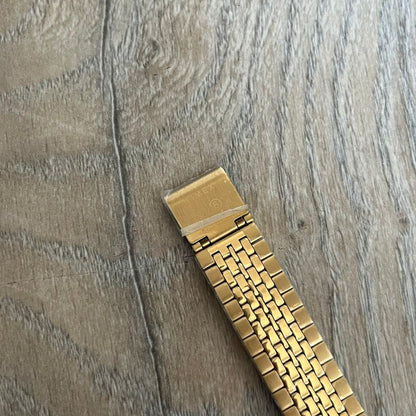 Timex x Maison Margiela MM6 Gold Watch + Bracelet Gift Set TWG067500QY is a collaborative reinterpretation of the classic Timex T80, released on October 24, 2024. Crafted from polished and brushed stainless steel, it features a 36mm digital case with Timex branding and a distinctive 0–23 numeral layout, including a subtle circled “6” nod to MM6 design language. The watch offers 100 ft water resistance, mineral glass, backlight, alarm, timer, and date functions, and is presented as a 2-in-1 gift set with an 