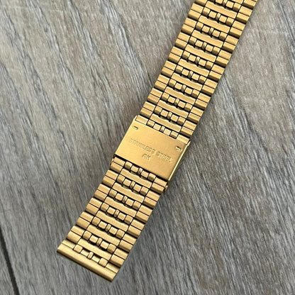 Timex x Maison Margiela MM6 Gold Watch + Bracelet Gift Set TWG067500QY is a collaborative reinterpretation of the classic Timex T80, released on October 24, 2024. Crafted from polished and brushed stainless steel, it features a 36mm digital case with Timex branding and a distinctive 0–23 numeral layout, including a subtle circled “6” nod to MM6 design language. The watch offers 100 ft water resistance, mineral glass, backlight, alarm, timer, and date functions, and is presented as a 2-in-1 gift set with an 