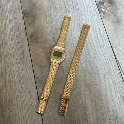 Timex x Maison Margiela MM6 Gold Watch + Bracelet Gift Set TWG067500QY is a collaborative reinterpretation of the classic Timex T80, released on October 24, 2024. Crafted from polished and brushed stainless steel, it features a 36mm digital case with Timex branding and a distinctive 0–23 numeral layout, including a subtle circled “6” nod to MM6 design language. The watch offers 100 ft water resistance, mineral glass, backlight, alarm, timer, and date functions, and is presented as a 2-in-1 gift set with an 