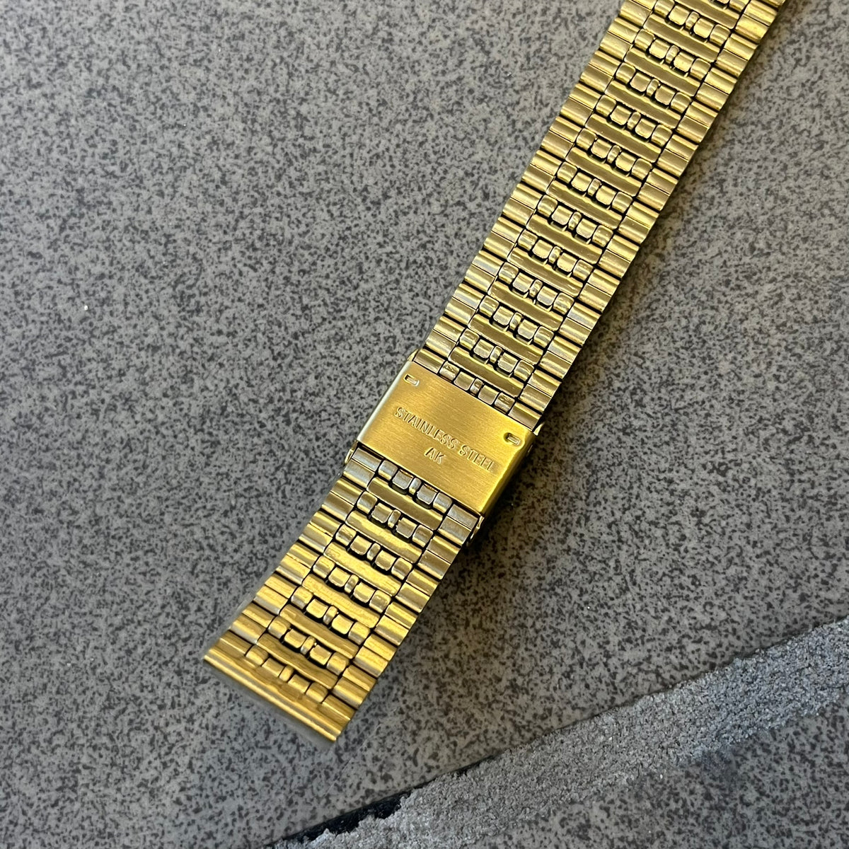 Timex x Maison Margiela MM6 Gold Watch + Bracelet Gift Set TWG067500QY is a collaborative reinterpretation of the classic Timex T80, released on October 24, 2024. Crafted from polished and brushed stainless steel, it features a 36mm digital case with Timex branding and a distinctive 0–23 numeral layout, including a subtle circled “6” nod to MM6 design language. The watch offers 100 ft water resistance, mineral glass, backlight, alarm, timer, and date functions, and is presented as a 2-in-1 gift set with an 