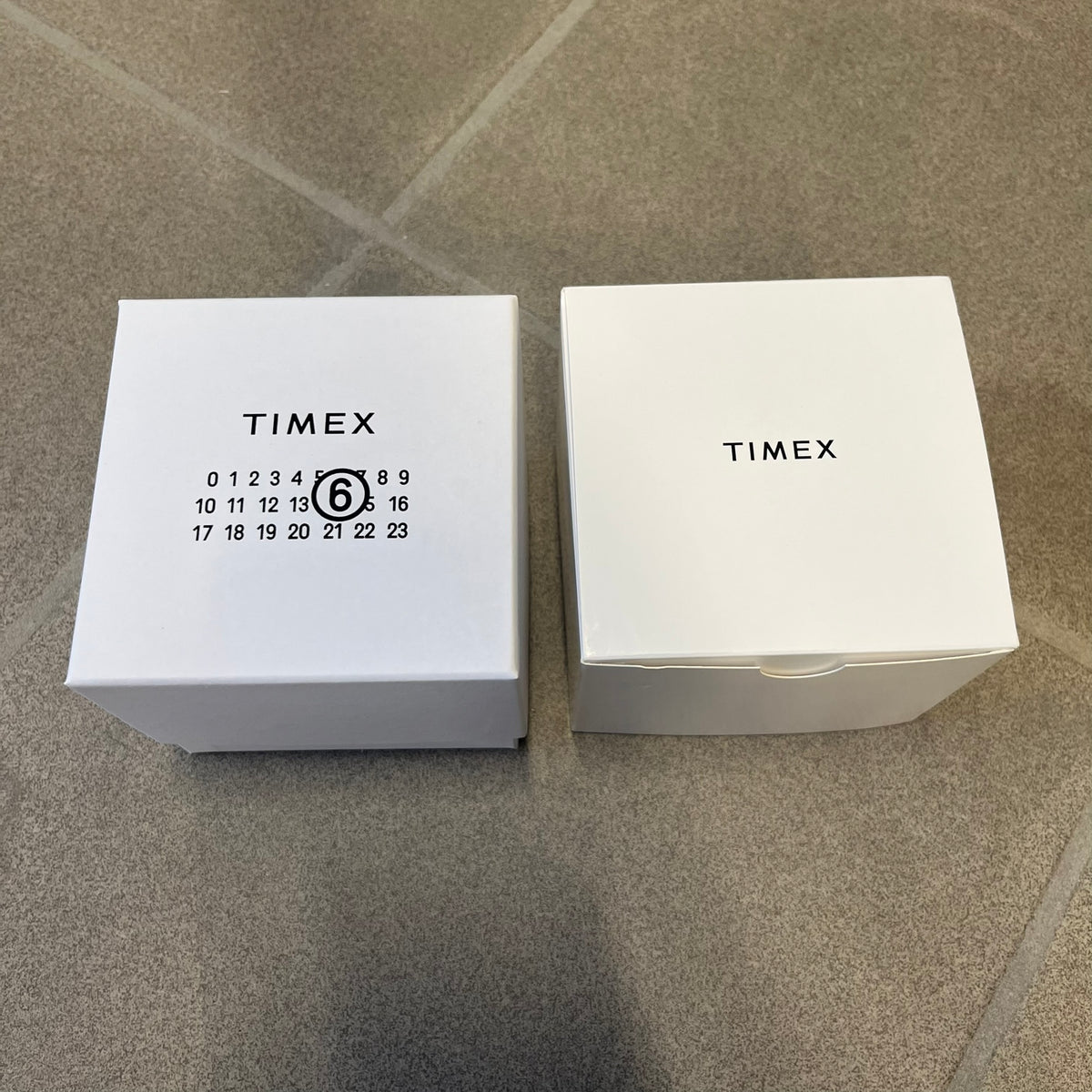 Timex x Maison Margiela MM6 Gold Watch + Bracelet Gift Set TWG067500QY is a collaborative reinterpretation of the classic Timex T80, released on October 24, 2024. Crafted from polished and brushed stainless steel, it features a 36mm digital case with Timex branding and a distinctive 0–23 numeral layout, including a subtle circled “6” nod to MM6 design language. The watch offers 100 ft water resistance, mineral glass, backlight, alarm, timer, and date functions, and is presented as a 2-in-1 gift set with an 