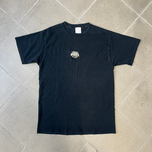 Tomb Raider 2001 Embroidered Logo Tee is a minimalistic black, 100% cotton T-shirt with an embroidered Lara Croft Tomb Raider logo in white and gold tones at the center. The neck tag carries 2001 Paramount licensing.