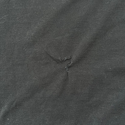 Tomb Raider Lara Croft 2006 Legend Tee is a black V-neck T-shirt made from 100% cotton on a Hanes blank. The front features the Lara Croft: Tomb Raider Legend cover graphic with Lara Croft’s face and the game title printed below. A white Eidos logo is printed on the sleeve, referencing the official game publisher.