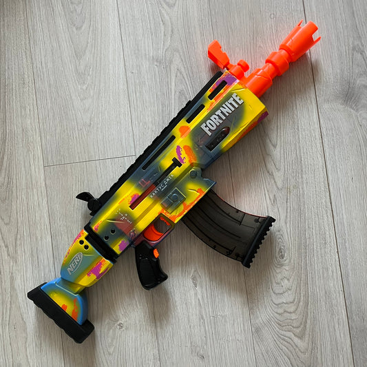 Toy gun with 'Fortnite' branding on a wooden floor