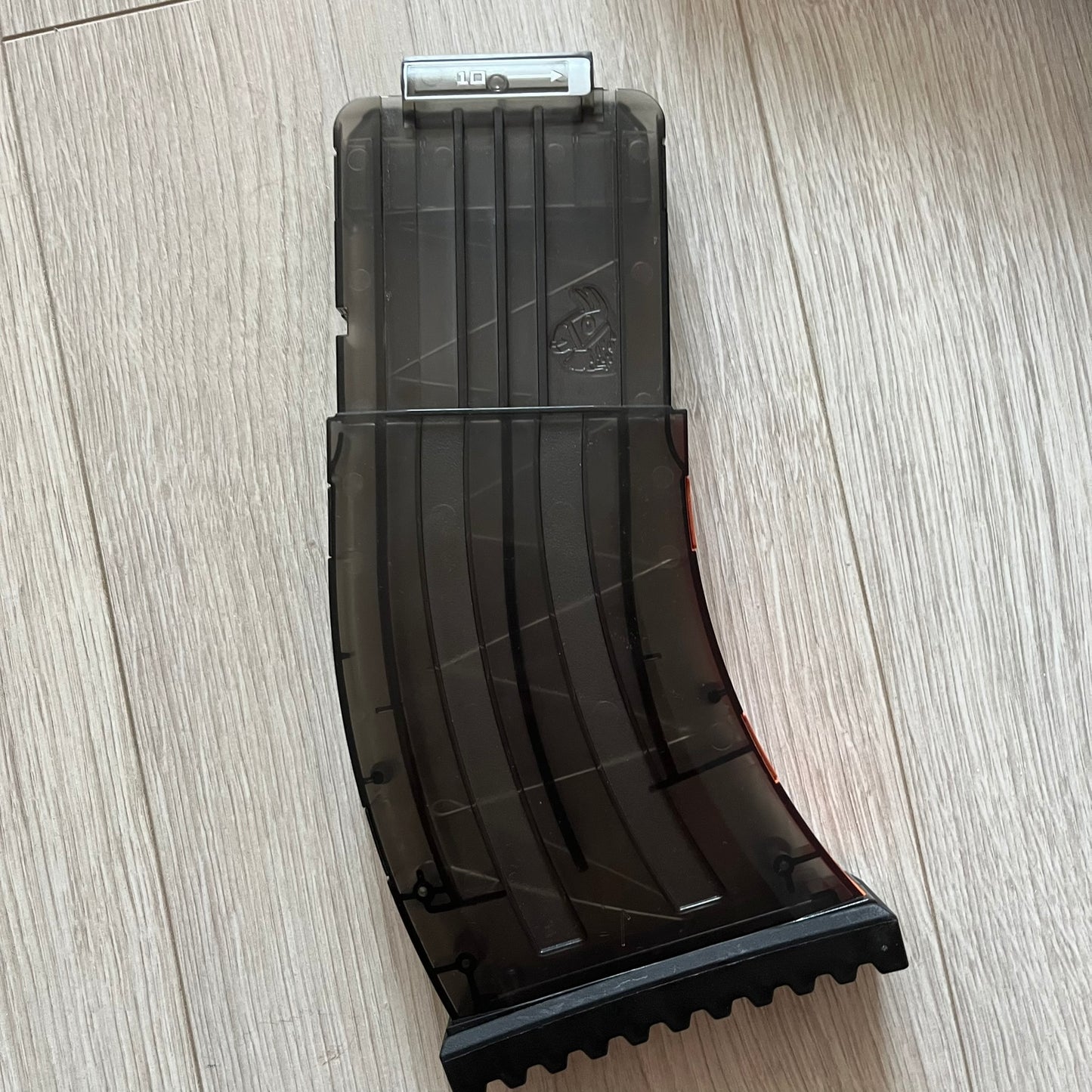 Black plastic magazine on a light wooden surface