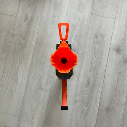 Orange and black tool on a gray wooden floor