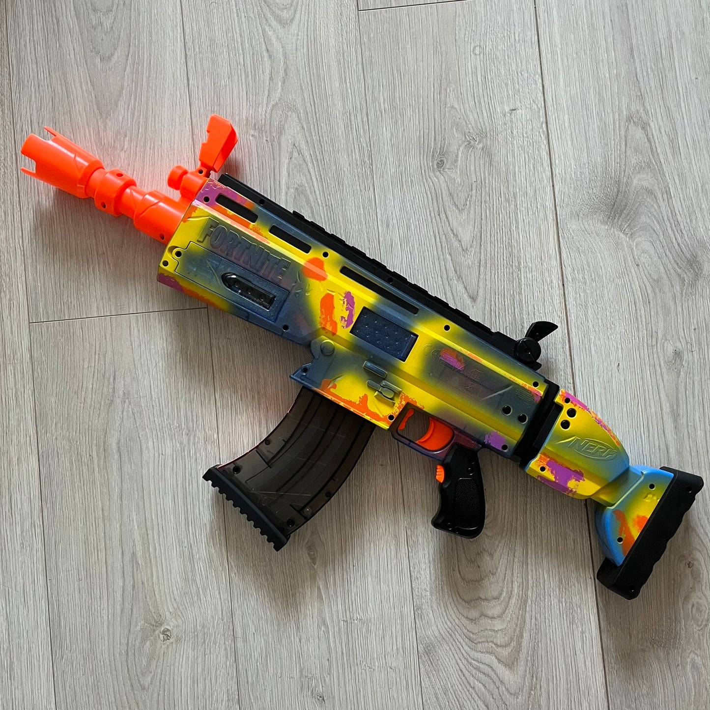 Colorful toy gun on a wooden floor