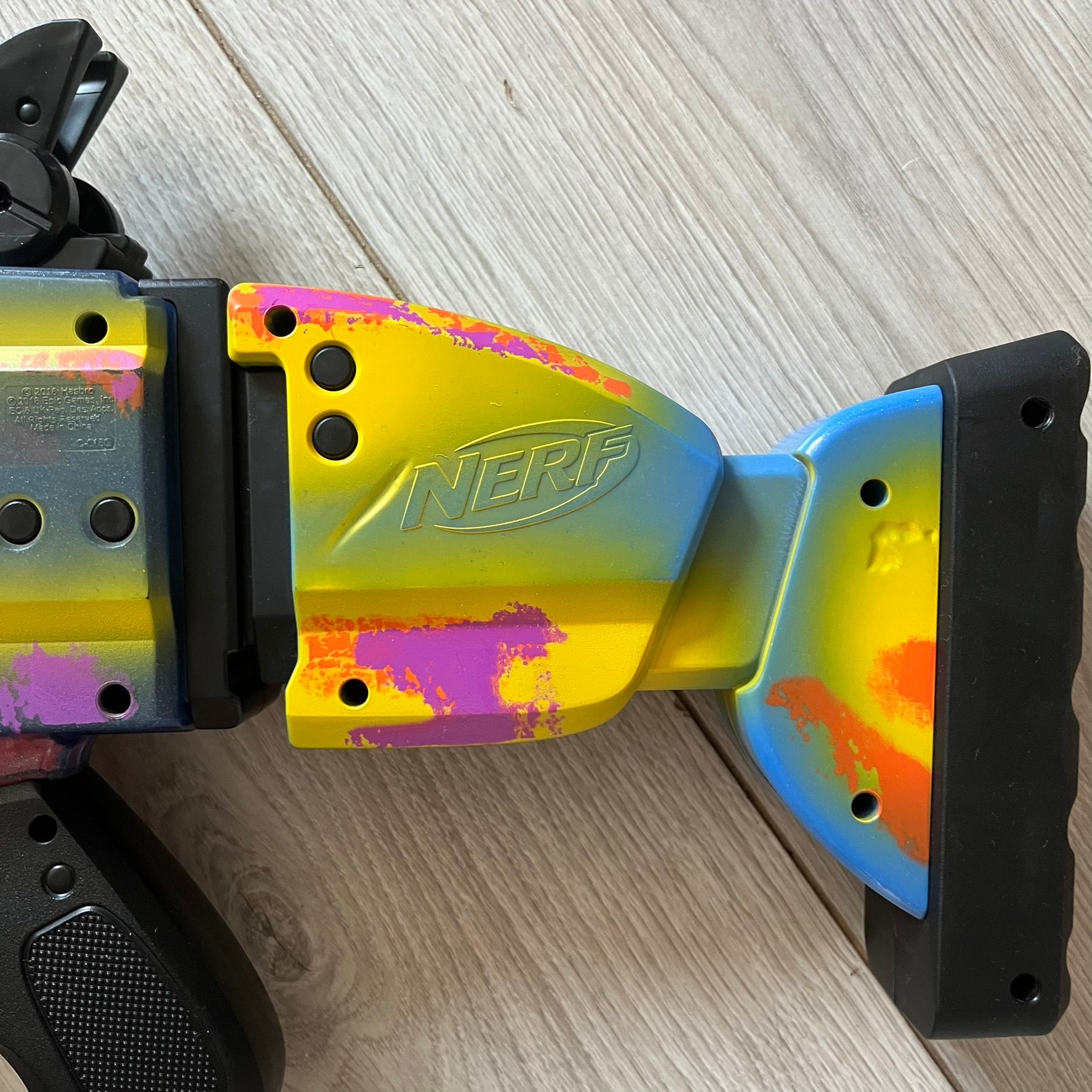 Colorful Nerf toy blade on a wooden surface