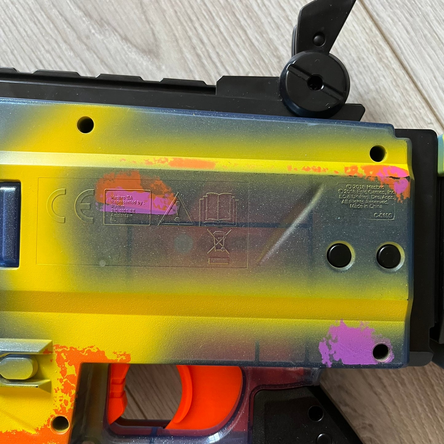 Close-up of a yellow and black tool with visible branding on a wooden surface