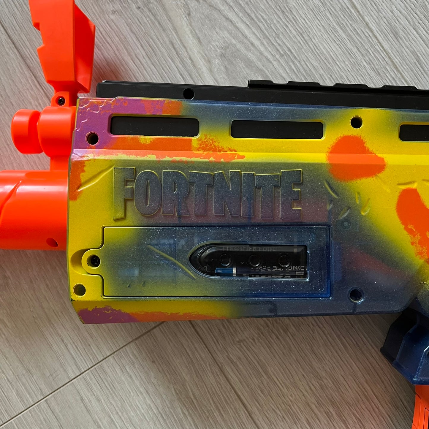 Toy gun with 'Fortnite' branding on a wooden floor
