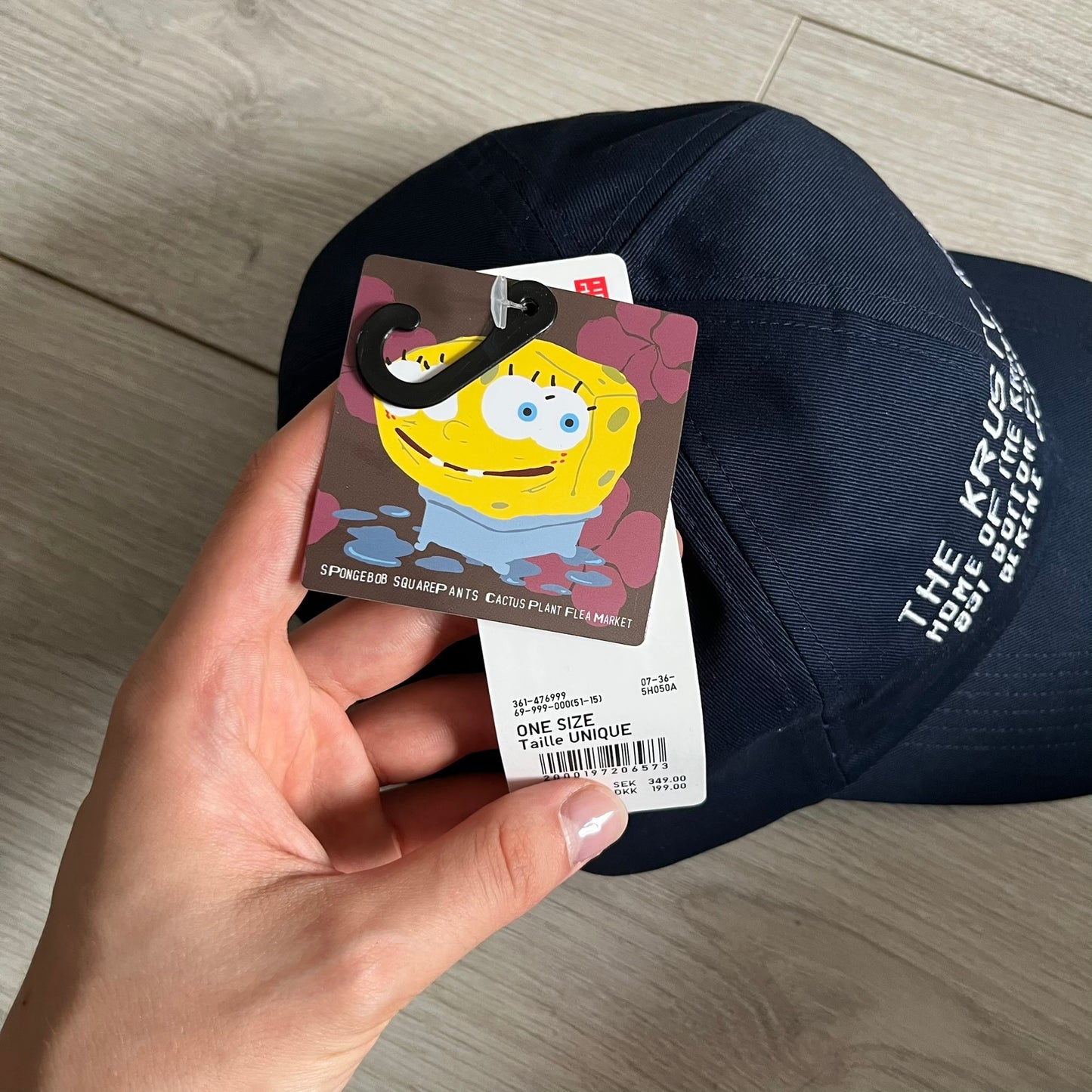 Uniqlo x CPFM Spongebob Navy Cap from FW24, released on 12/12/2024. This navy UV protection cap features a playful SpongeBob SquarePants design, part of the Uniqlo x Cactus Plant Flea Market collaboration. Lightweight and functional, it combines casual style with sun protection, making it a fun and practical accessory.