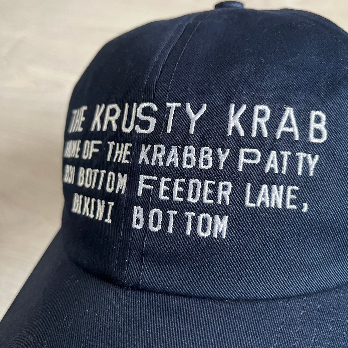 Uniqlo x CPFM Spongebob Navy Cap from FW24, released on 12/12/2024. This navy UV protection cap features a playful SpongeBob SquarePants design, part of the Uniqlo x Cactus Plant Flea Market collaboration. Lightweight and functional, it combines casual style with sun protection, making it a fun and practical accessory.