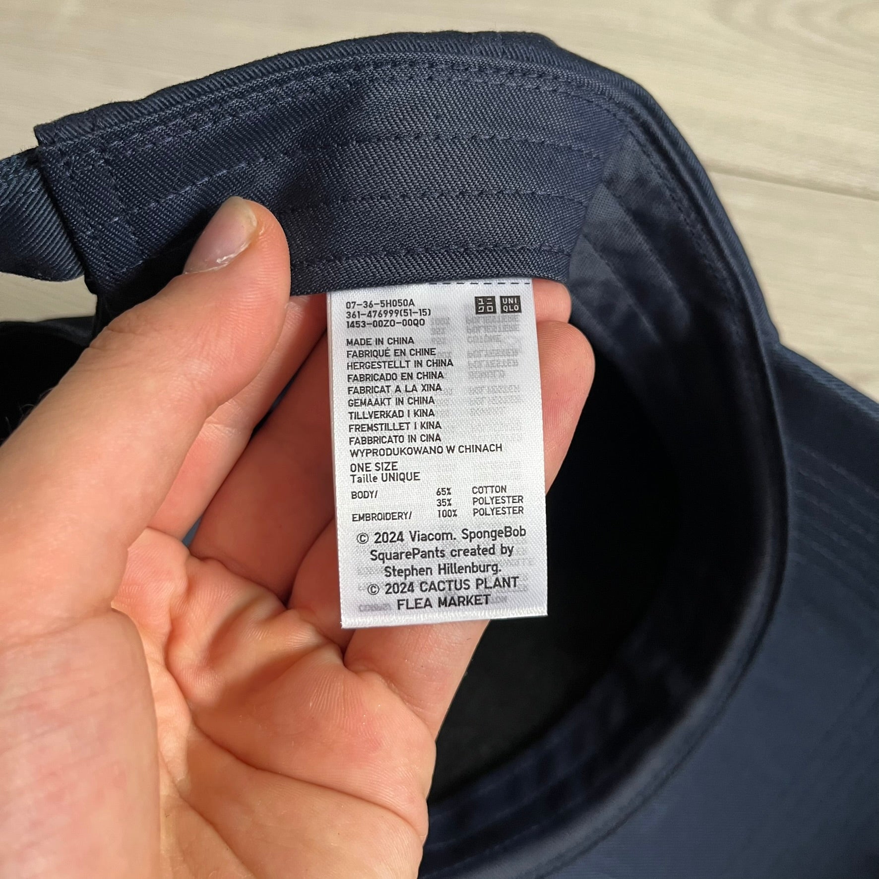 Uniqlo x CPFM Spongebob Navy Cap from FW24, released on 12/12/2024. This navy UV protection cap features a playful SpongeBob SquarePants design, part of the Uniqlo x Cactus Plant Flea Market collaboration. Lightweight and functional, it combines casual style with sun protection, making it a fun and practical accessory.