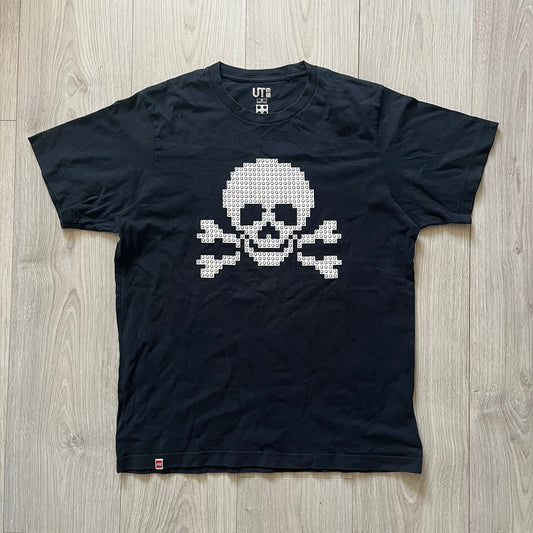 Black boxer briefs with a white pixelated skull design on a wooden floor.