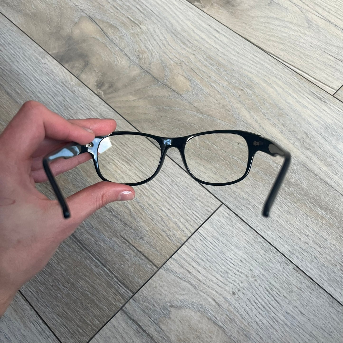 Valve Black Promo Eyeglasses are non-prescription promotional glasses featuring simple black plastic frames with clear zero-strength lenses. Small white Valve logos are placed on both sides of the frame arms. The design is minimal and intended as branded promotional eyewear.
