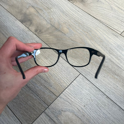 Valve Black Promo Eyeglasses are non-prescription promotional glasses featuring simple black plastic frames with clear zero-strength lenses. Small white Valve logos are placed on both sides of the frame arms. The design is minimal and intended as branded promotional eyewear.