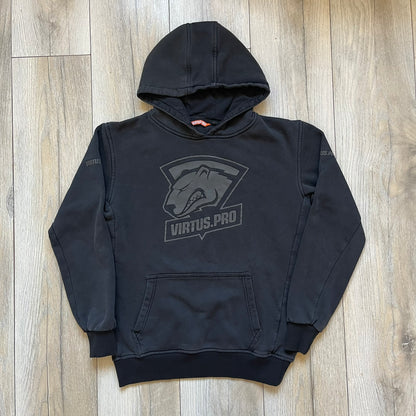 Virtus Pro 2020s Washed Black Hoodie is a black pullover hoodie featuring the Virtus.Pro logo on the front. Made from soft, high-quality materials, it offers a comfortable fit with durability suitable for casual wear or gaming. This hoodie was released in the 2020s as official Virtus.Pro esports merchandise.