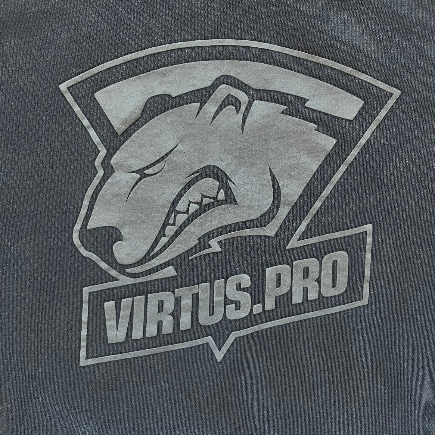 Virtus Pro 2020s Washed Black Hoodie is a black pullover hoodie featuring the Virtus.Pro logo on the front. Made from soft, high-quality materials, it offers a comfortable fit with durability suitable for casual wear or gaming. This hoodie was released in the 2020s as official Virtus.Pro esports merchandise.
